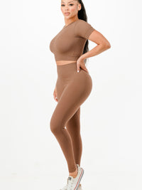 Ribbed seamless activewear set featuring cropped top and high-waist leggings in a stylish brown color.
