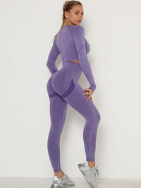 Model wearing a purple seamless leggings set featuring a crop top and high-waisted leggings.