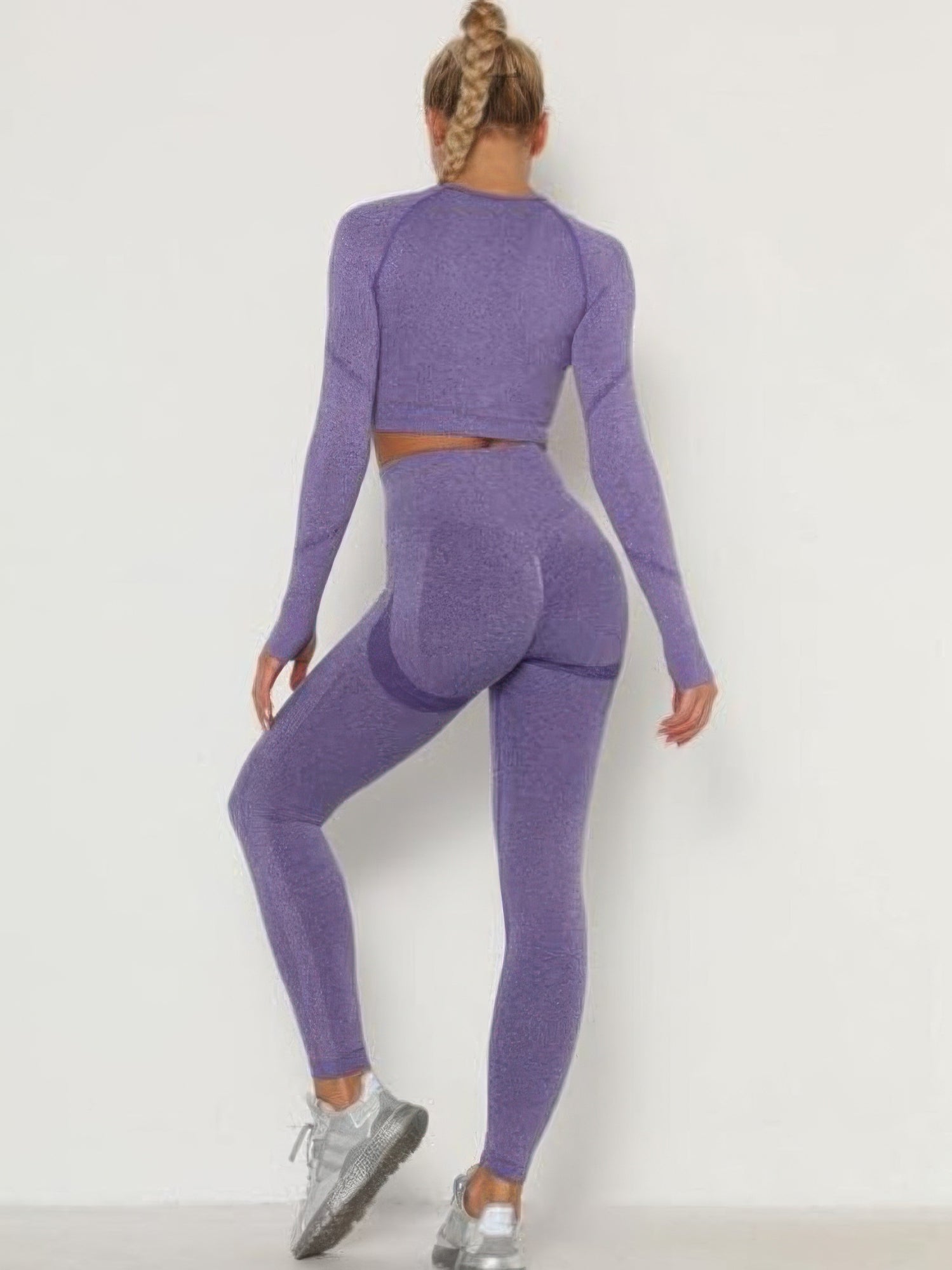 Seamless leggings set in purple featuring a crop top and high-waisted leggings with a stylish back view.