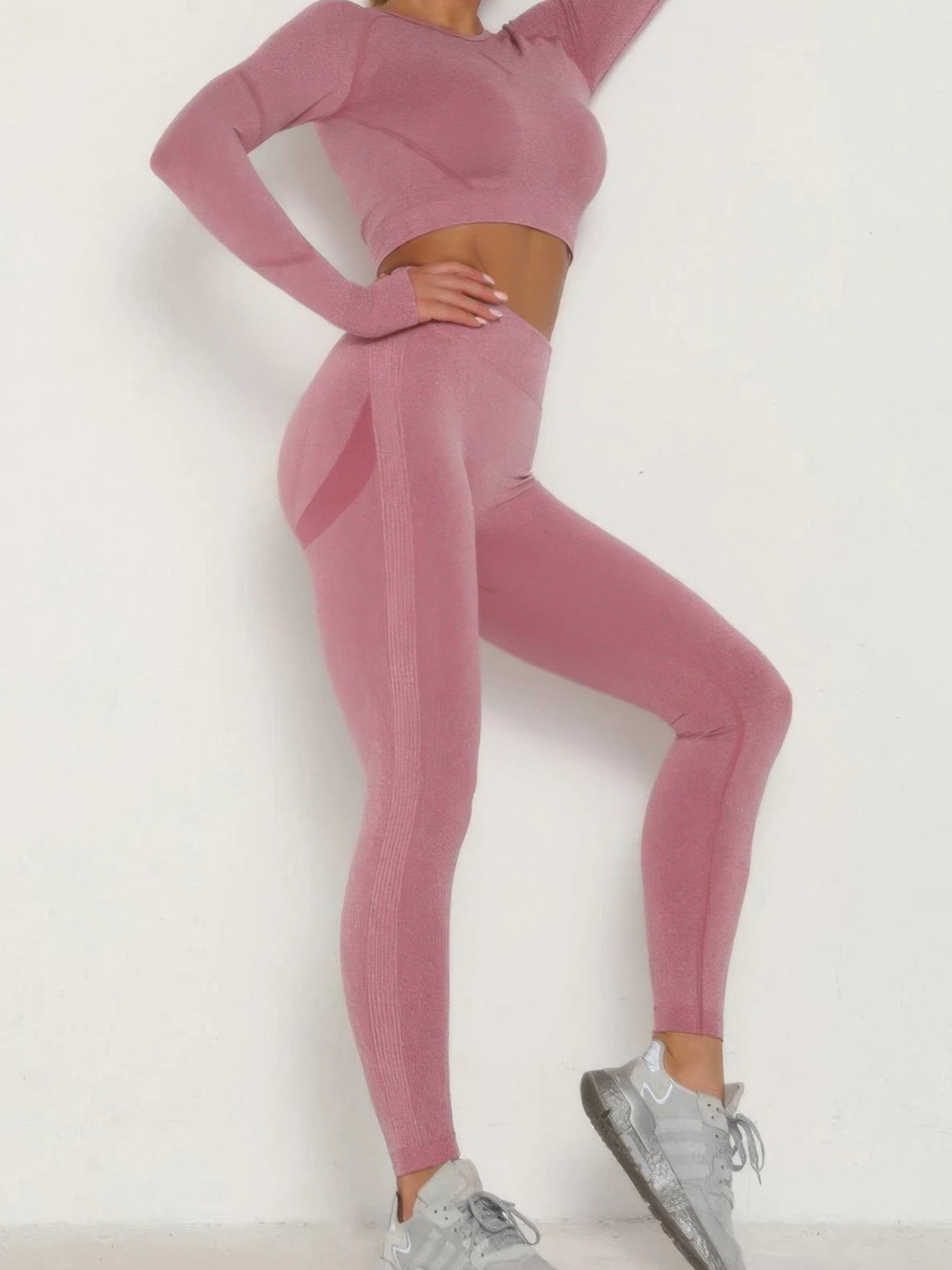 Seamless activewear set featuring a pink seamless crop top and matching leggings, ideal for stylish workouts.