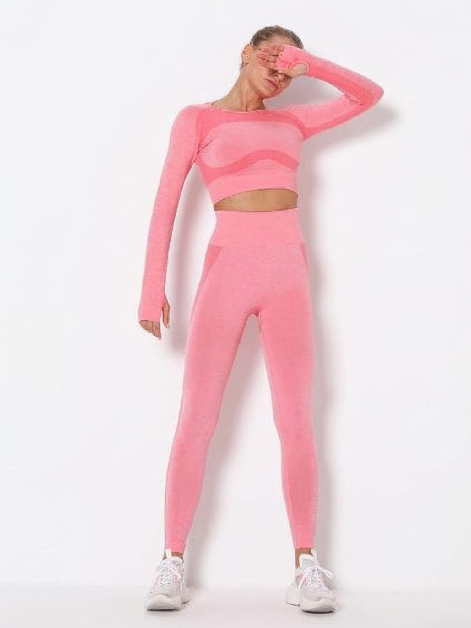 Seamless long sleeve yoga set in vibrant pink color, featuring a stylish cut-out design and a flattering fit.