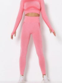 Seamless long sleeve yoga set in pink color block design, featuring long sleeves and form-fitting leggings.