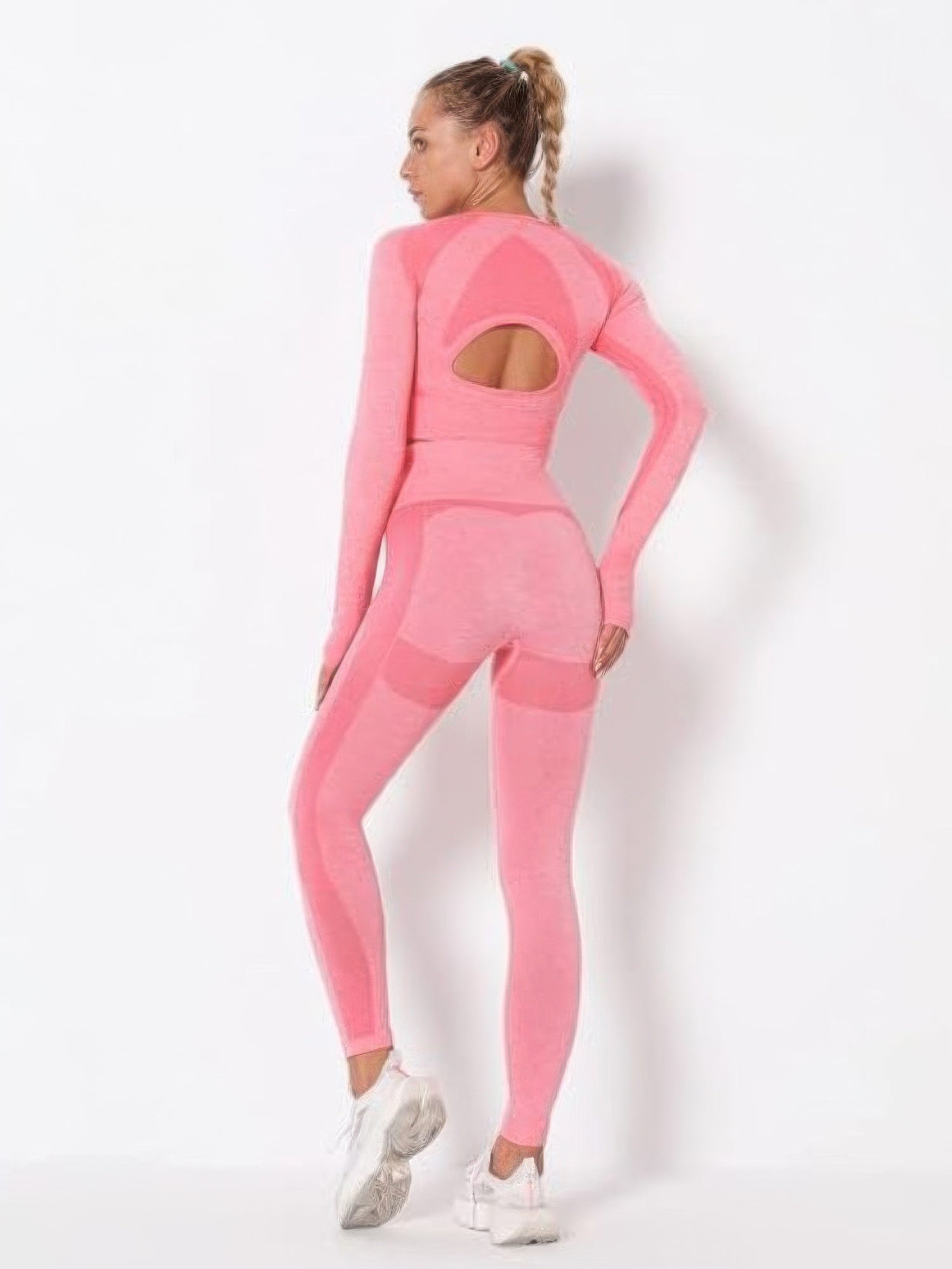 Model showcasing the seamless long sleeve yoga set in pink, highlighting its cut-out details and comfortable fit.