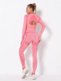 Model showcasing the seamless long sleeve yoga set in pink, highlighting its cut-out details and comfortable fit.