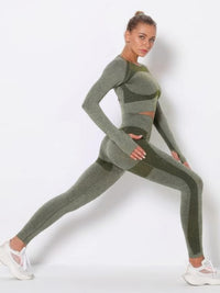 Model showcasing the seamless long sleeve yoga set in green, demonstrating a stretch pose.