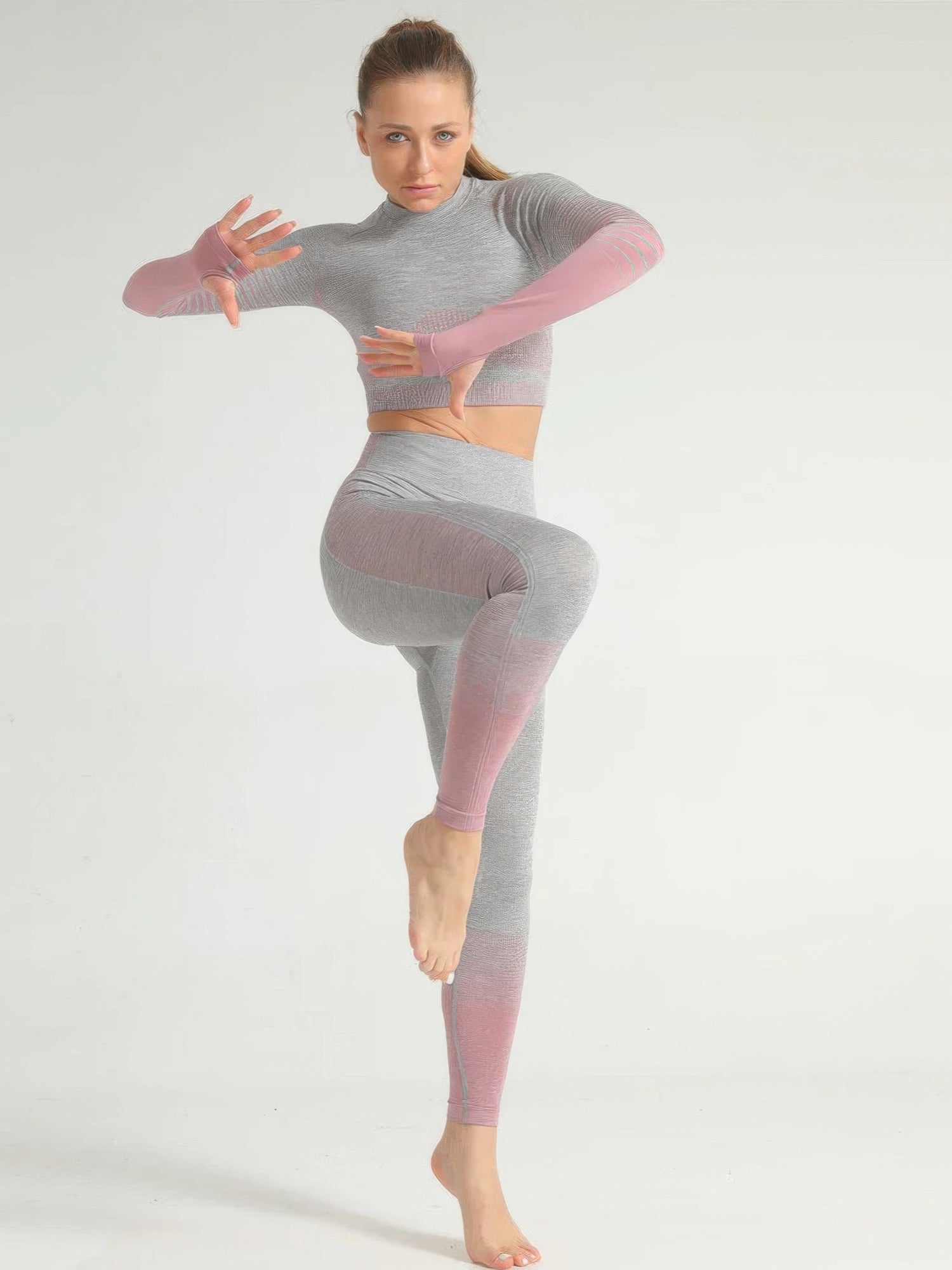 Model showcasing the stripe seamless yoga set featuring a long sleeve crop top and full-length leggings.