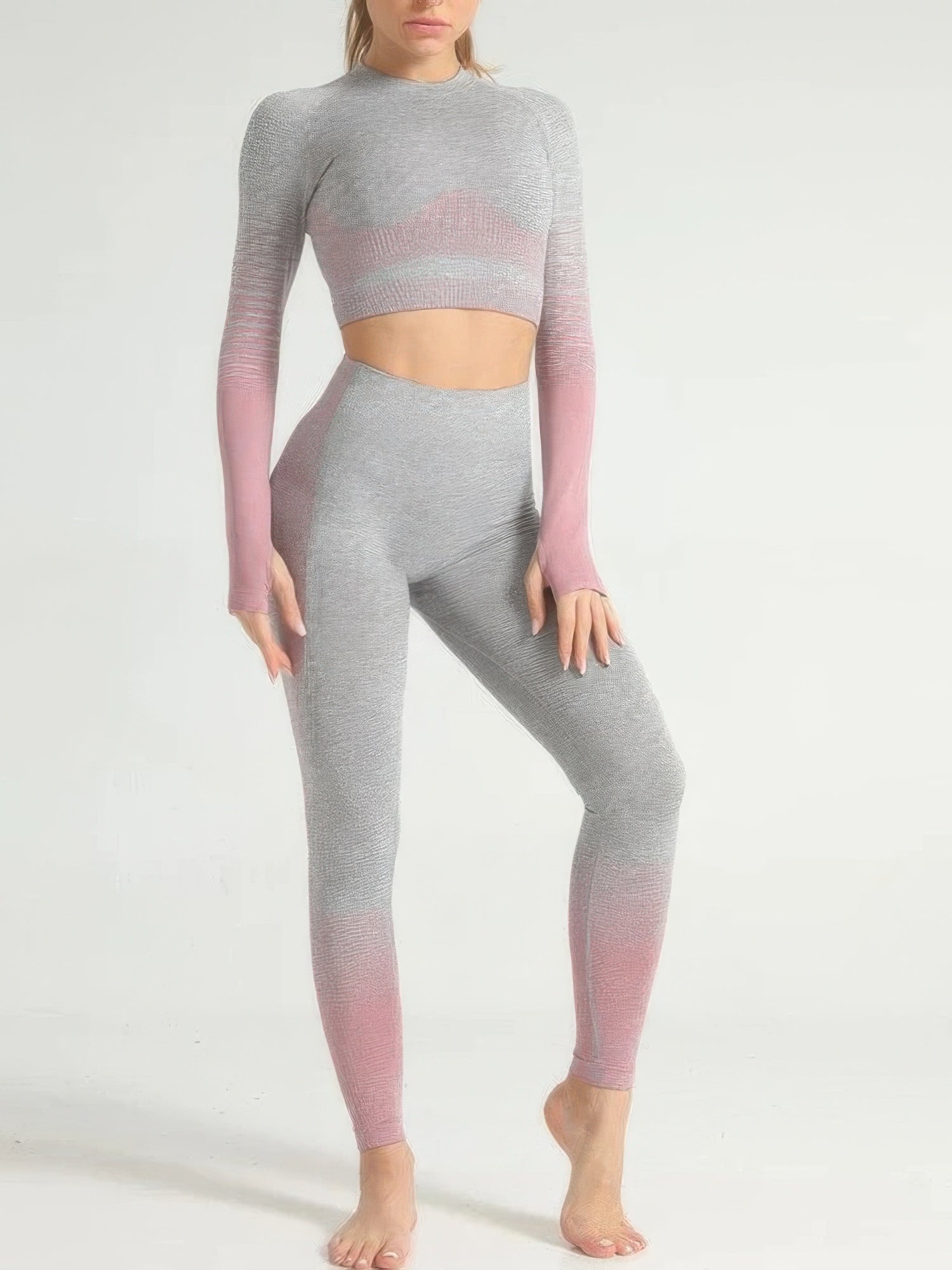 Woman wearing a stripe seamless yoga set with long sleeve crop top and skinny-fit leggings in gray and pink color.