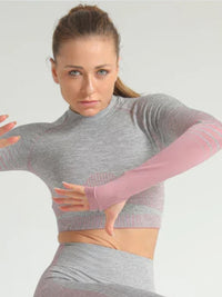 Model wearing a stripe seamless yoga set, showcasing the long sleeve crop top in action.