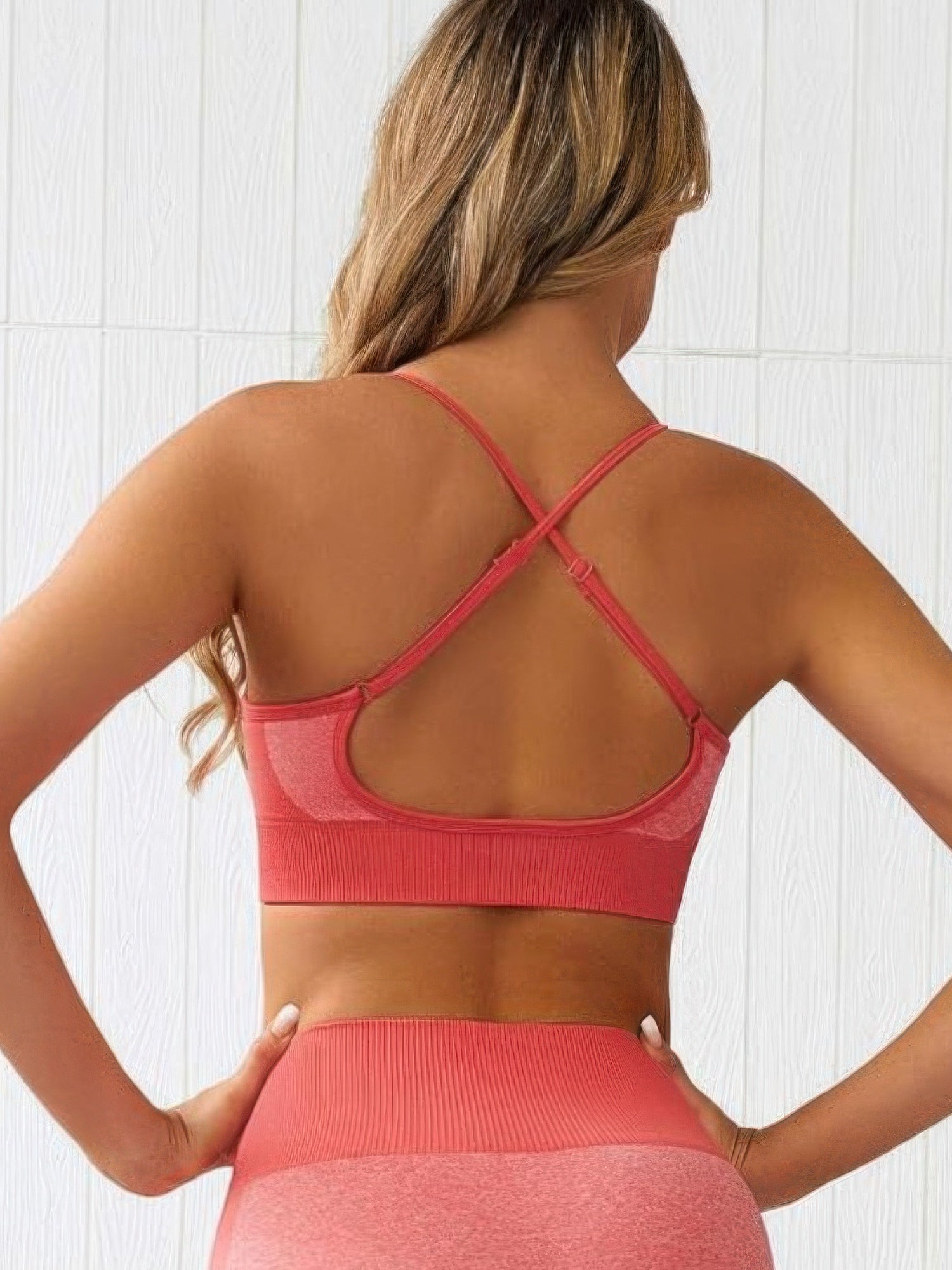 Back view of a seamless activewear two piece set showcasing a stylish cross-back crop tank top.