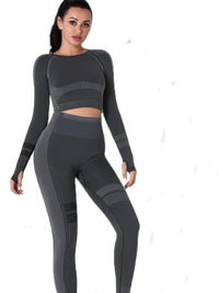 Seamless long sleeve yoga set model wearing a gray crop top and high-waisted leggings for comfort and style.