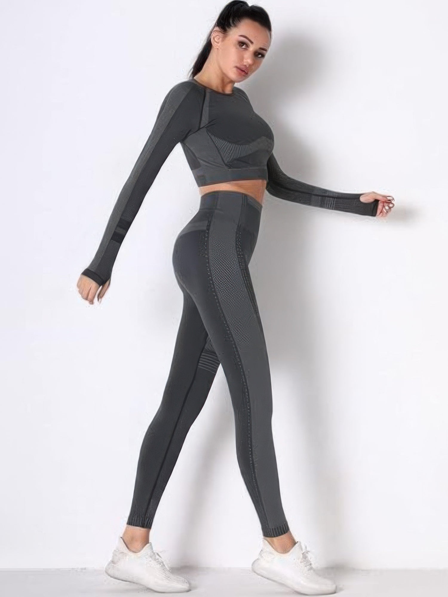Model showcasing a seamless long sleeve yoga set with high-waisted leggings in grey, ideal for workouts and comfort.