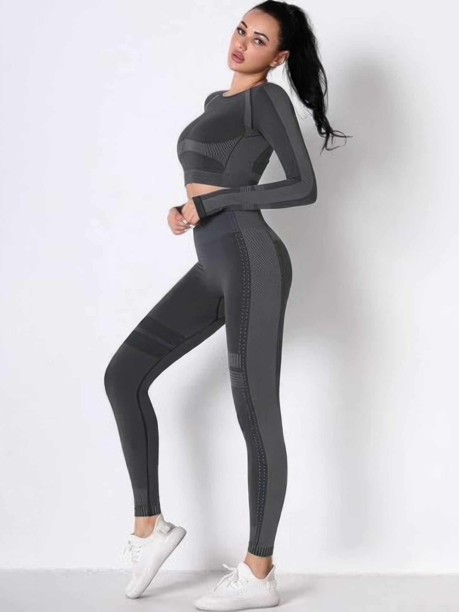 Seamless long sleeve yoga set featuring a gray crop top and high-waisted leggings, perfect for workouts and comfort.