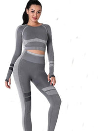 Seamless yoga set with long sleeve crop top and high-waisted leggings in gray for workouts and comfort.