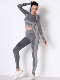 Seamless yoga set featuring long sleeve crop top and high-waisted leggings in gray, designed for comfort and flexibility.