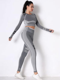 Model showcasing a seamless yoga set in gray featuring a long sleeve crop top and high-waisted leggings.