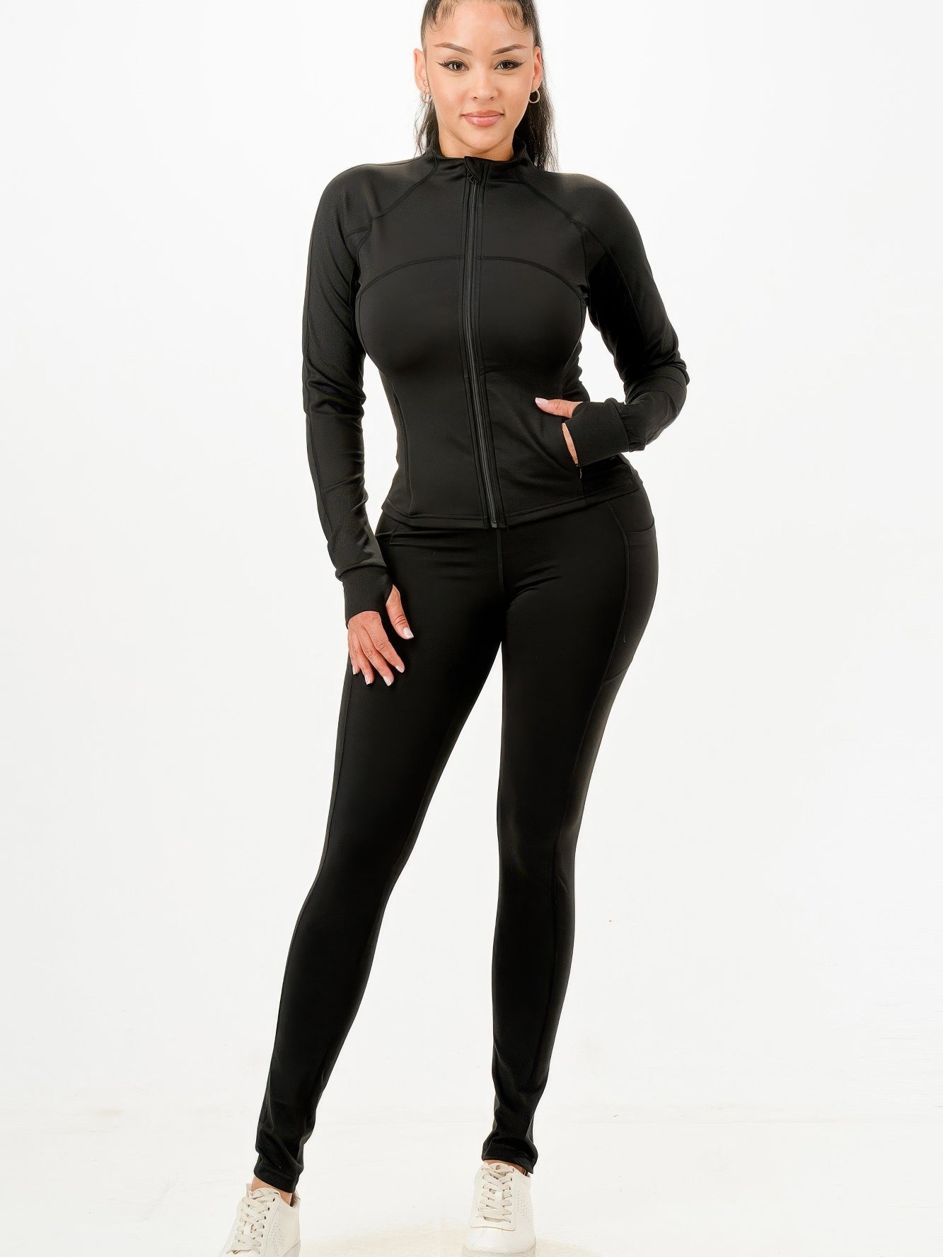 Activewear jacket and legging set modeled by a woman, showcasing a sleek design perfect for workouts and casual outings.