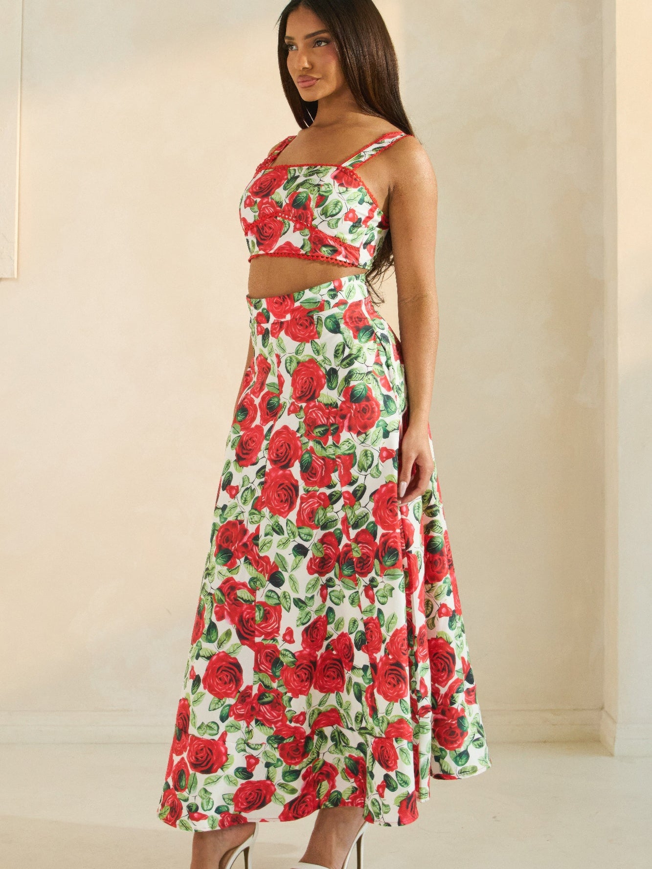 Rose Romance Two-Piece Set featuring a woman in a floral crop top and long skirt with a red rose print.