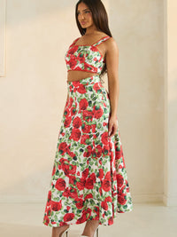 Rose Romance Two-Piece Set featuring a woman in a floral crop top and long skirt with a red rose print.
