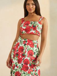 Model showcasing the Rose Romance Two-Piece Set with bold red rose print and lace trim details.