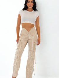 Model showcasing V Cut Cargo Pants in beige, featuring a V-shaped waistline and wide-leg fit for a trendy streetwear look.