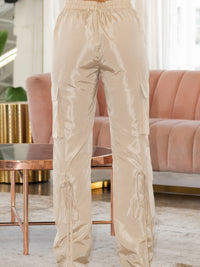 V Cut Cargo Pants in beige with drawstring and side pockets, showcasing unique wide-leg fit and V-shaped waist.