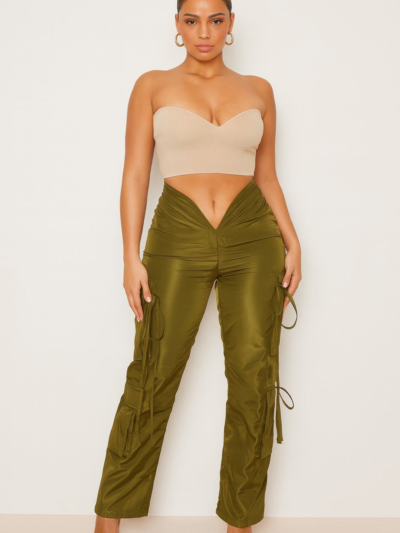 V Cut Cargo Pants styled with a strapless top, featuring a V-shaped waistline and cargo pockets in olive green.
