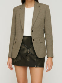 Model wearing a stylish Mid Waist Mini Skirt with a blazer, showcasing a modern and edgy outfit.
