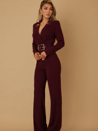 Woman wearing a Blazer Suit Long Sleeve Jumpsuit, showcasing a tailored fit and stylish belt, perfect for modern elegance.