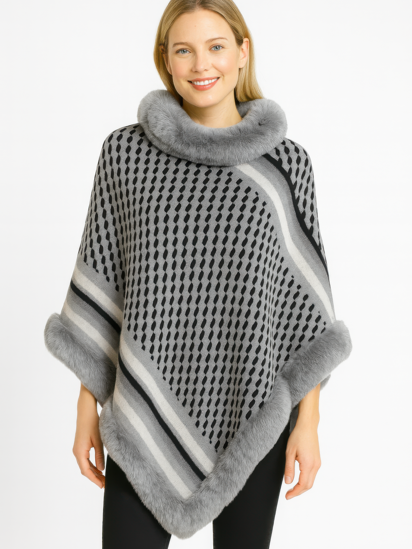 Patterned Knit Poncho With Faux Fur Trim modeled by a smiling woman, featuring a geometric pattern and soft faux fur trim.