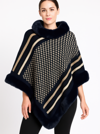 Model wearing a stylish Patterned Knit Poncho With Faux Fur Trim in navy and beige geometric design.