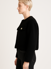 Faux Shearling Button-Front Cropped Jacket displayed on a model, showcasing its stylish cropped design and soft fabric.