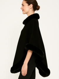 Classic Black Poncho With Faux Fur Trim shown in profile, featuring soft fabric and elegant design.