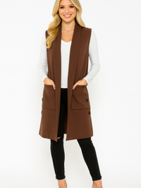 Structured Sleeveless Longline Vest With Pockets worn by a model, featuring a tailored fit and side pockets.