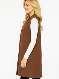 Model wearing a Structured Sleeveless Longline Vest With Pockets in brown, showcasing its sleek design and tailored silhouette.