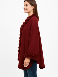 Open-Front Cape With Pom Faux Fur Trim in burgundy worn by a smiling woman, featuring plush pom trims for stylish layering.