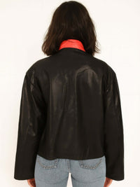 Back view of 1988 Vintage Motor Jacket in black leather with red collar, showcasing its sleek design and structure.