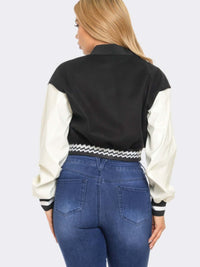 Back view of a woman wearing a Varsity Patchwork Y2k Jacket with a stylish design and elastic waistline.