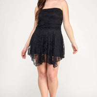 Plus Size Ots Lace Overlay Assym Dress modeled by a woman with a flowing skirt and lace details.