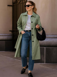 Fashionable woman wearing a Solid Long Sleeve Trench Coat Woman Lined with sunglasses and a handbag.