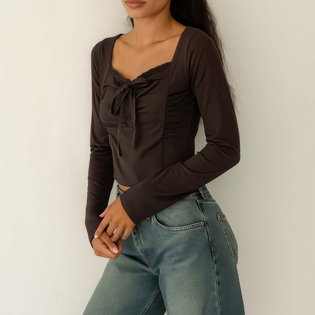 Long Sleeve Scrunch Bow Top worn with high-waisted jeans, showcasing a gathered front and bow accent.