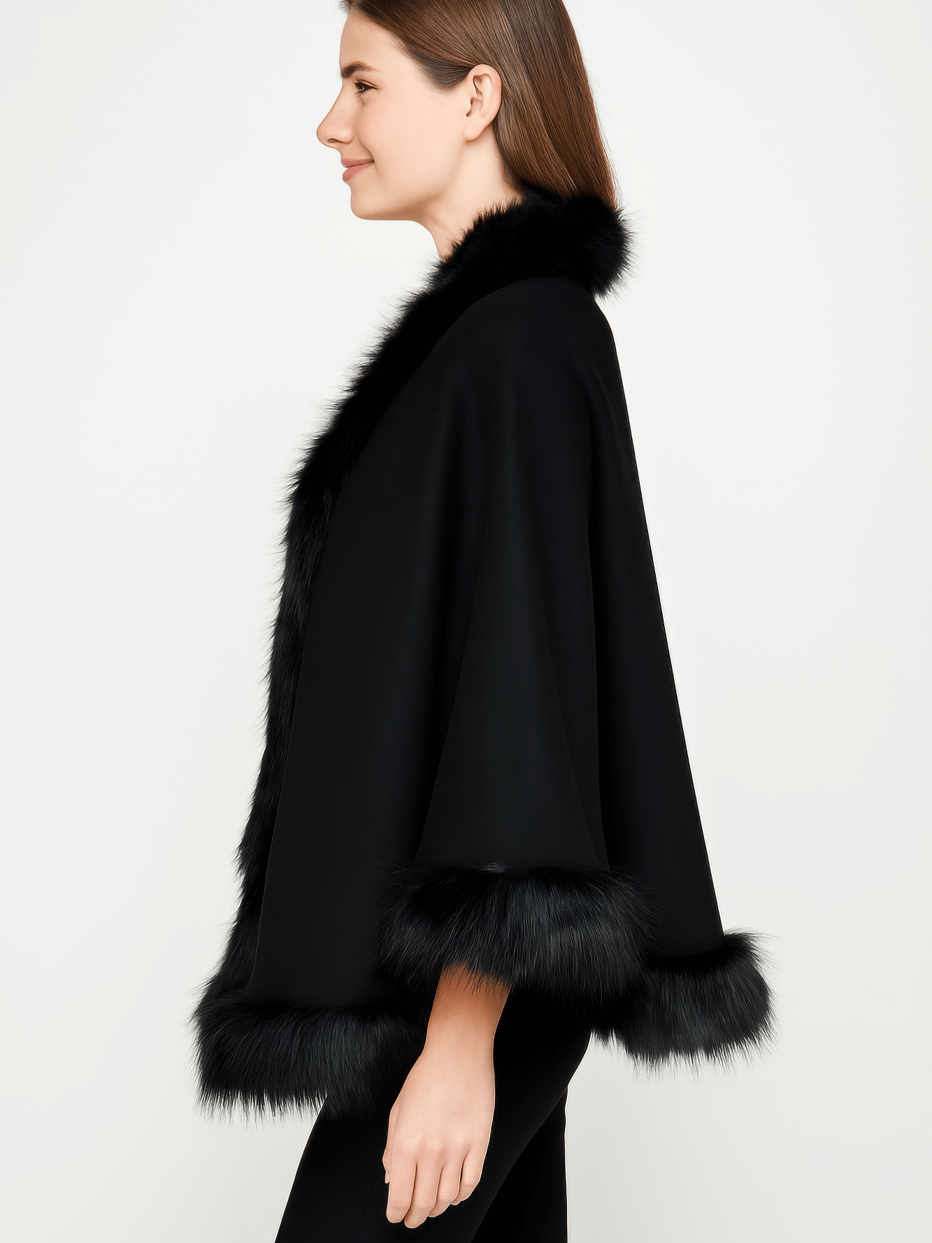Elegant profile of a model wearing a black Faux Fur Trim Cape with luxurious faux fur trim.