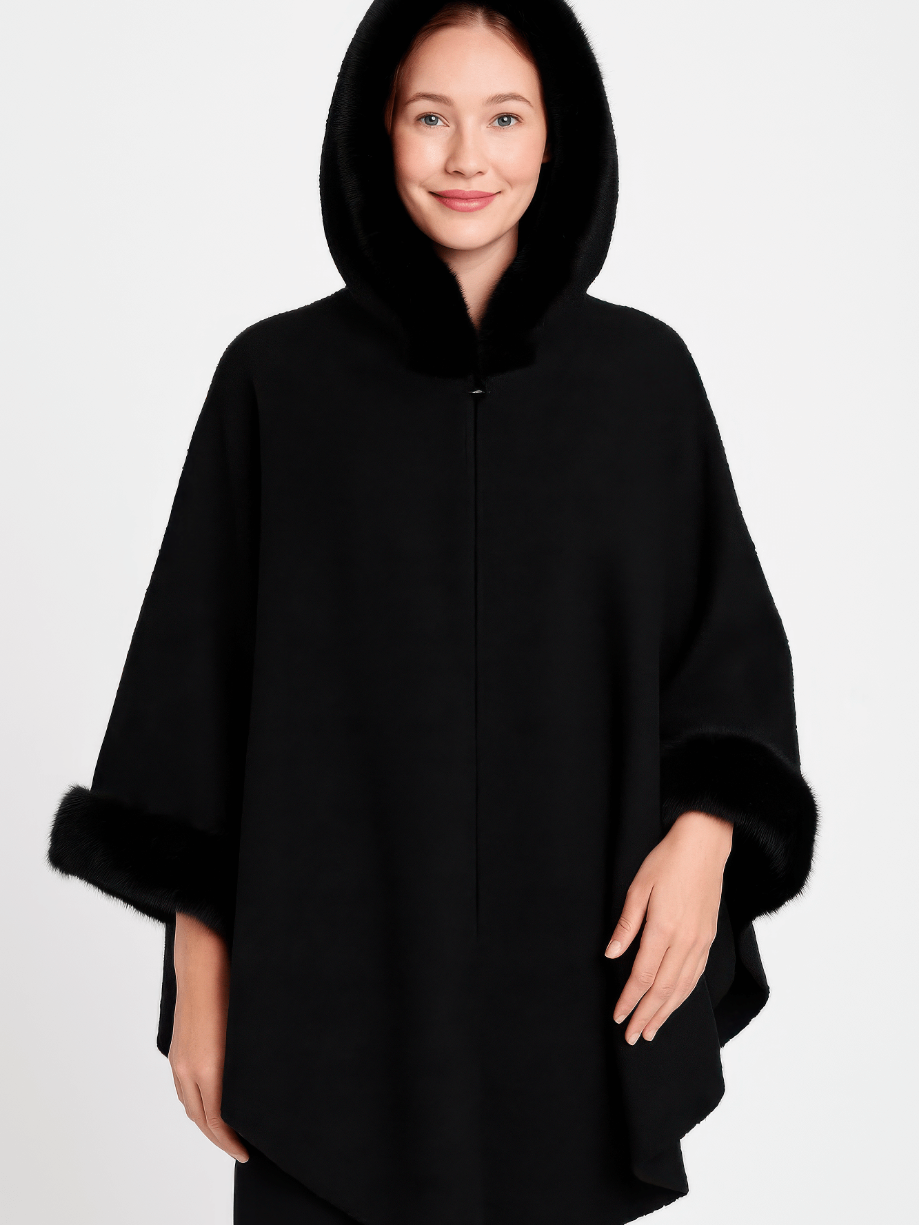 Hooded Faux Fur Trim Cape worn by a woman, showcasing its luxurious black fabric and plush faux fur trim.
