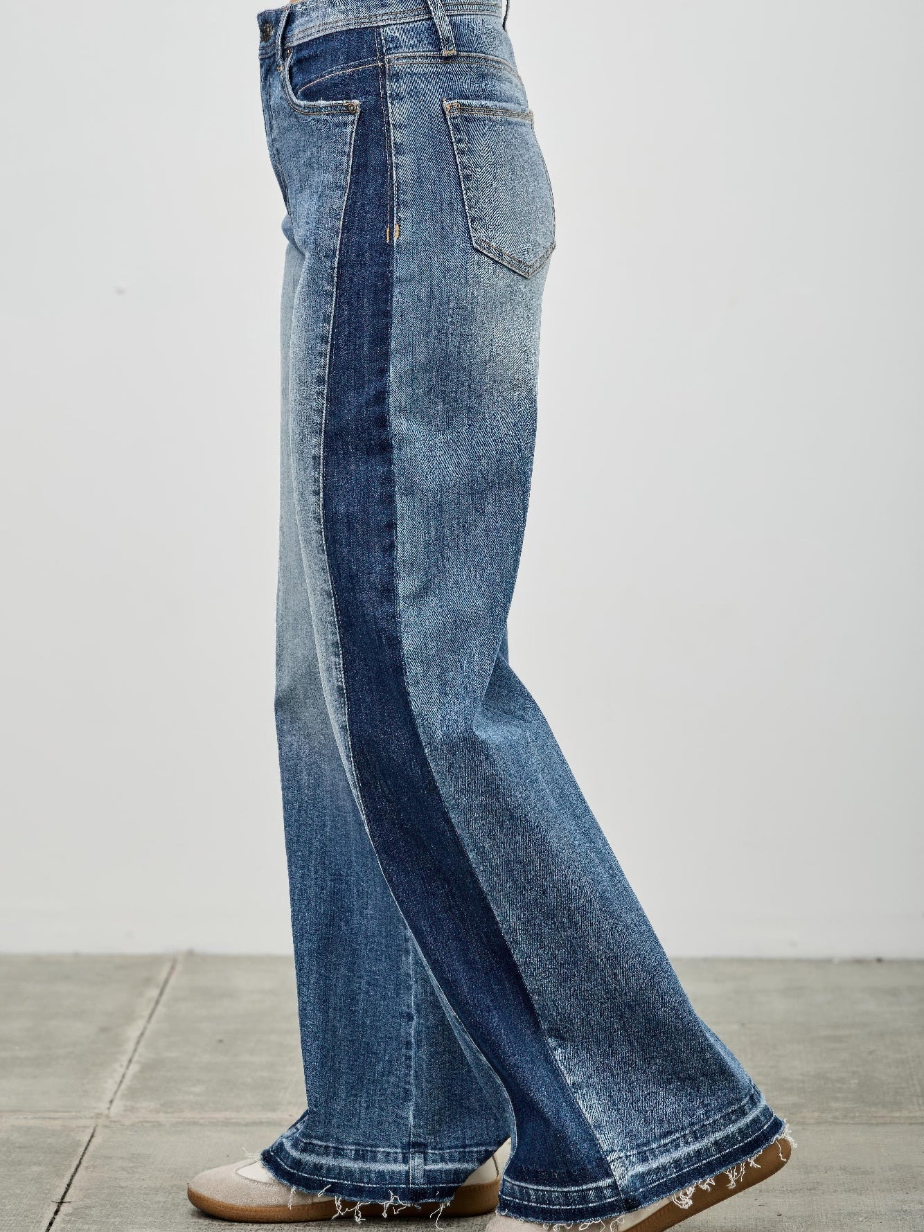High Rise Wide Leg W/release Hem And Side Contrast showcased from the side, featuring a raw hem and contrasting side panel.