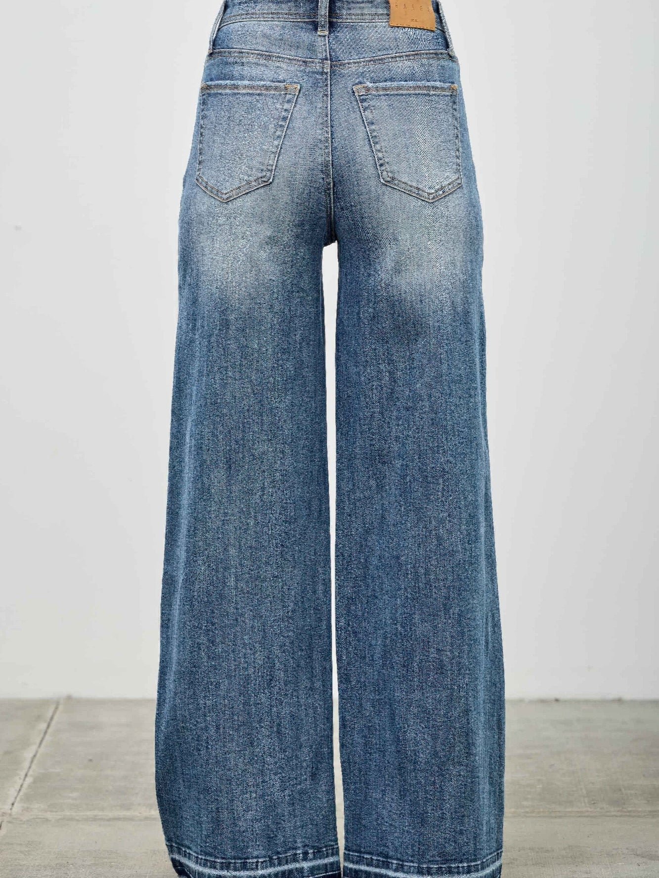 High Rise Wide Leg W/release Hem And Side Contrast view from the back showcasing the relaxed fit and release hem.