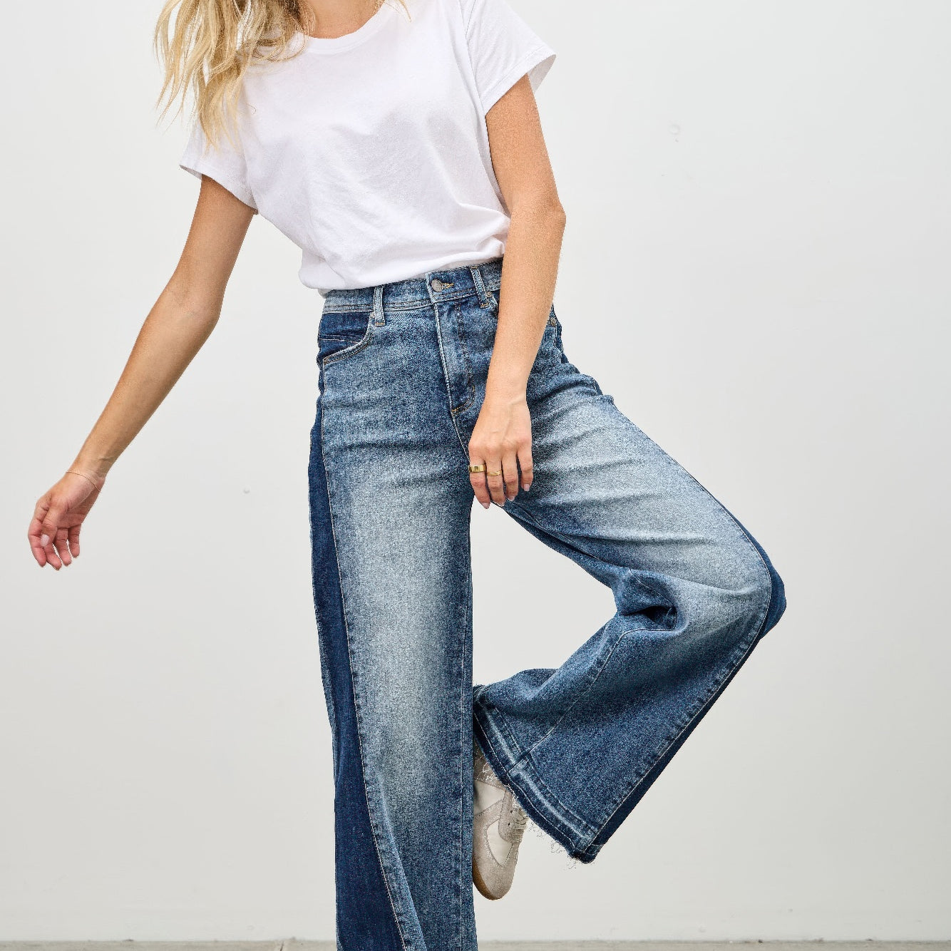 Model wearing High Rise Wide Leg W/release Hem And Side Contrast jeans with a white t-shirt, showcasing a stylish look.