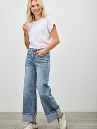 Mid Rise Cuffed Jeans With Stretch modeled with a casual white tee and stylish sneakers.