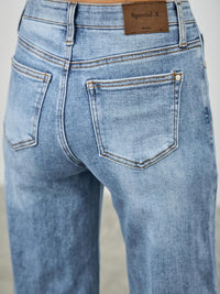 Mid Rise Cuffed Jeans With Stretch showing back view and cuffed hem in a soft blue wash.