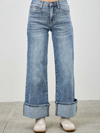 Mid Rise Cuffed Jeans With Stretch showcased on a model wearing stylish sneakers, highlighting the relaxed fit and cuffed hem.