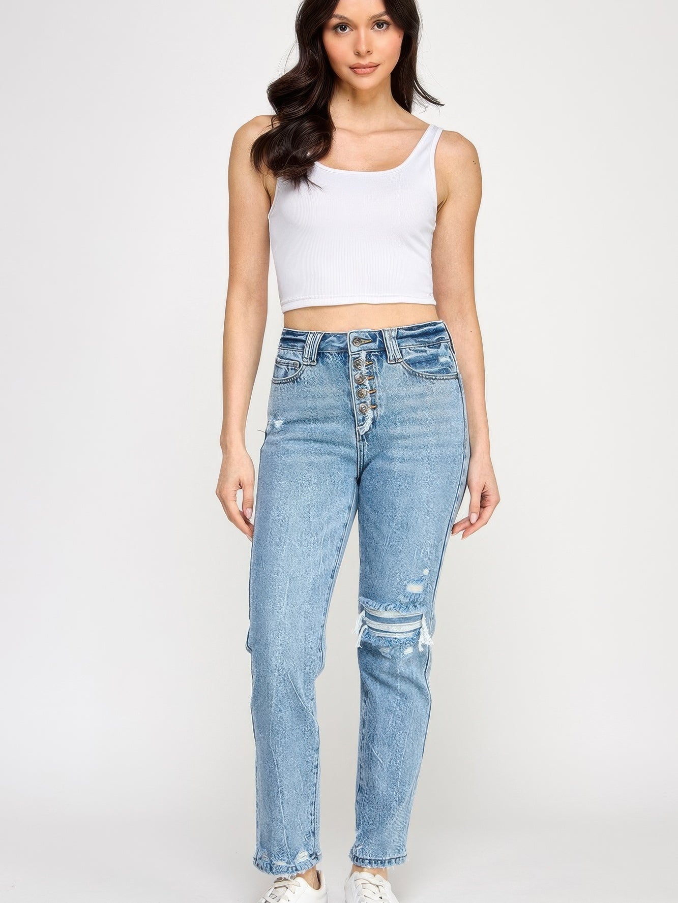 Model wearing High Rise Button Fly Crop Slim Straight denim jeans with a cropped white tank top.