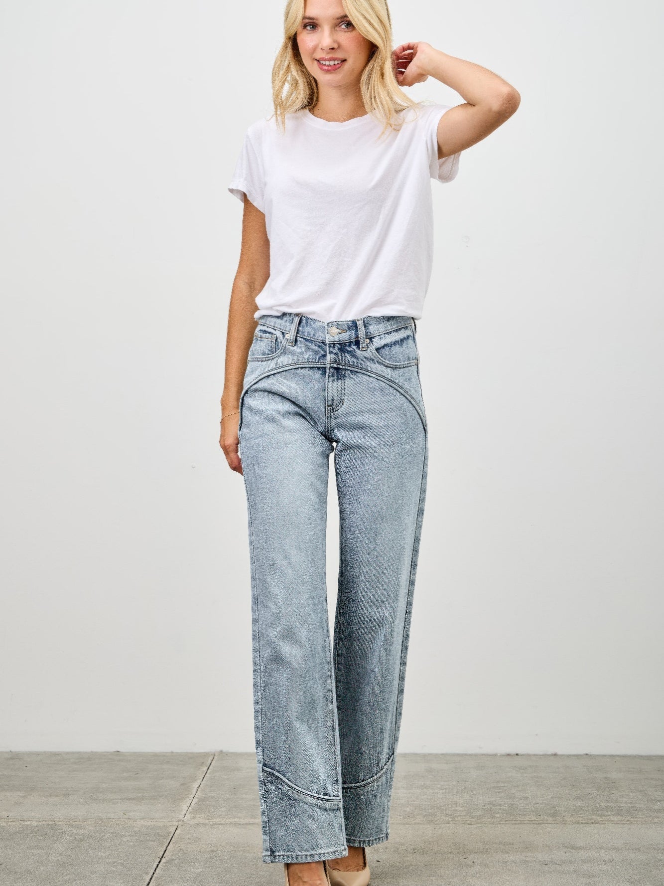 Model wearing Mid Rise Straight With Piping jeans with a white t-shirt and heels, showcasing refined denim style.